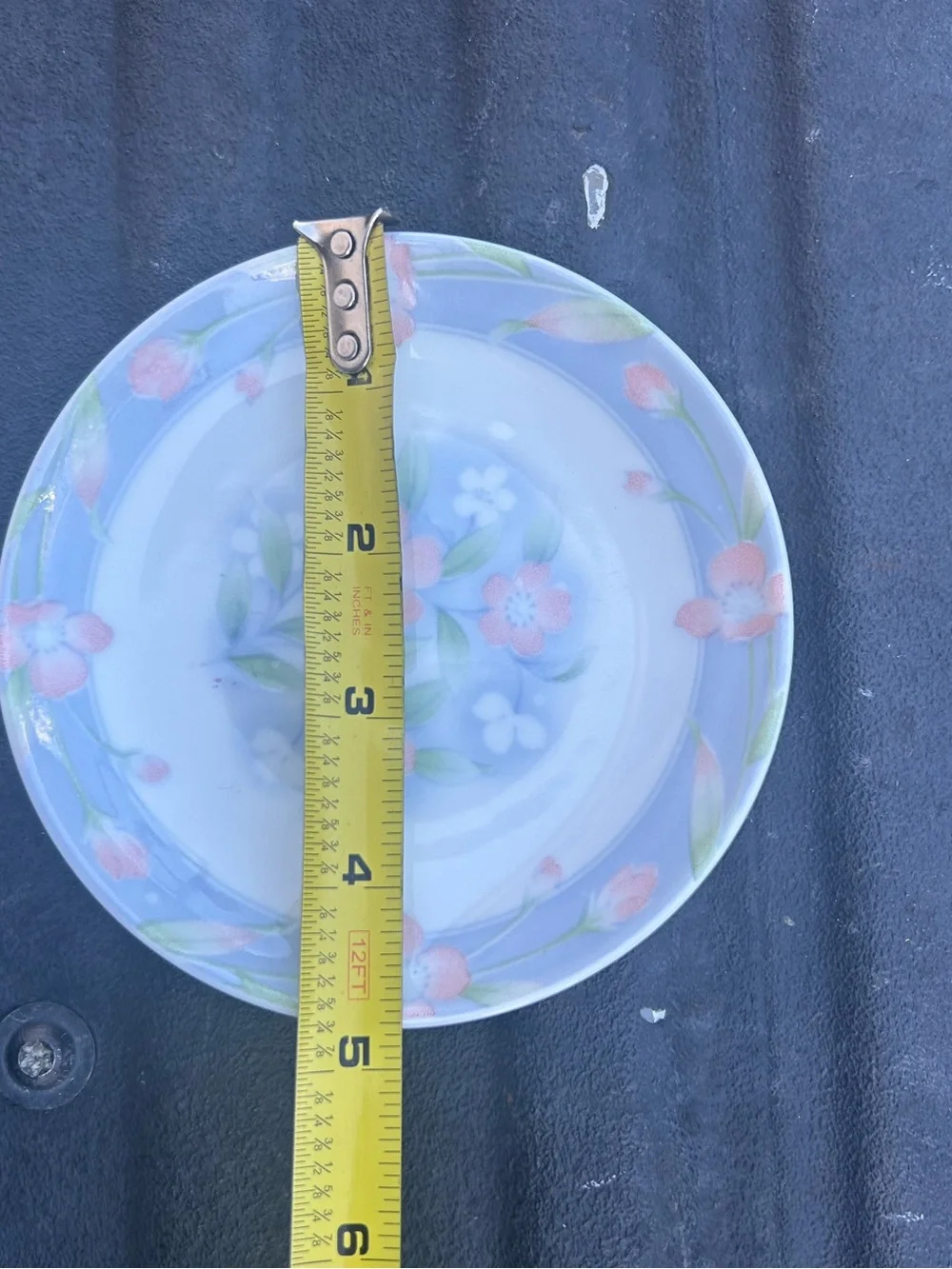 Vintage small butter pat dish featuring a light blue rim delicate floral patter
